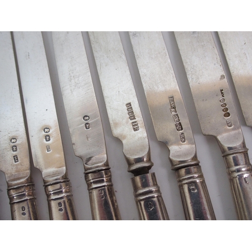 261 - A set of thirteen silver dessert knives