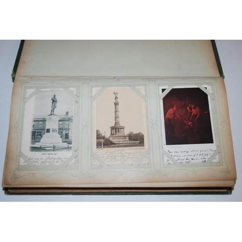 406 - An early 20th Century album of colour and black and white postcards