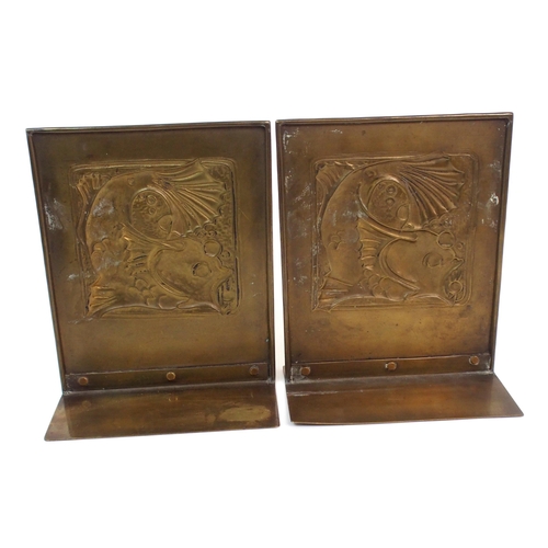 658 - A pair of Glasgow School Arts and Crafts brass bookends