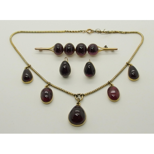 700 - A suite of garnet cabouchon jewellery