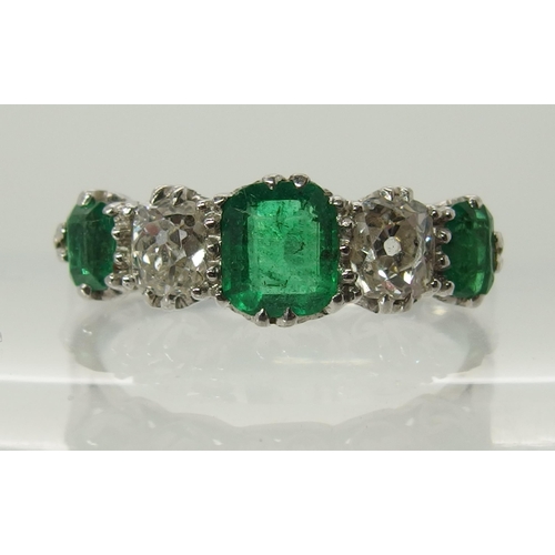 703 - A five stone emerald and diamond ring