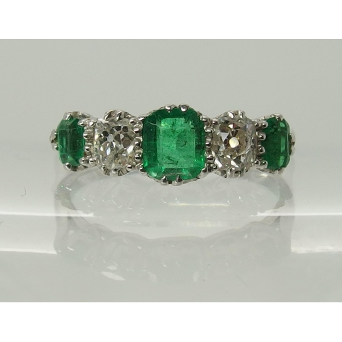 703 - A five stone emerald and diamond ring