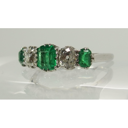 703 - A five stone emerald and diamond ring