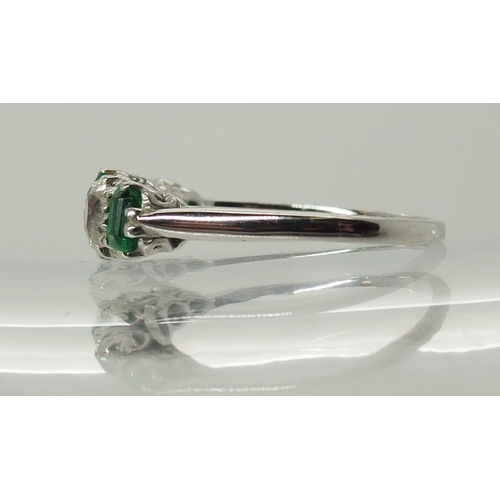 703 - A five stone emerald and diamond ring