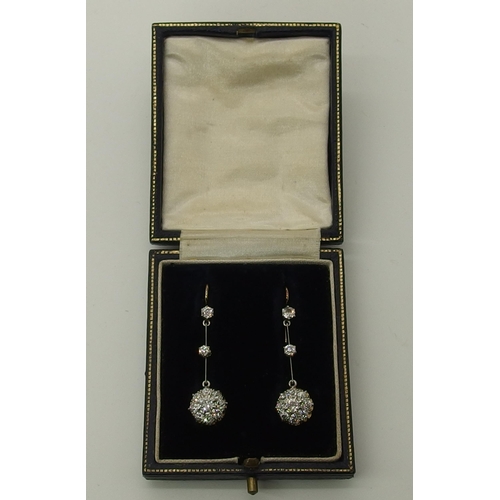 710 - A pair of diamond flower cluster drop earrings