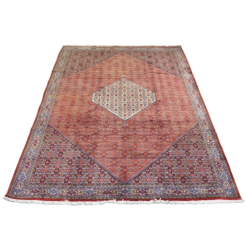 992 - A red ground fine Tabriz rug