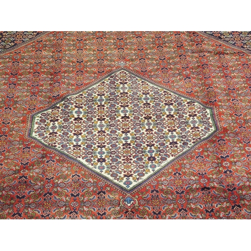 992 - A red ground fine Tabriz rug