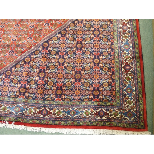 992 - A red ground fine Tabriz rug