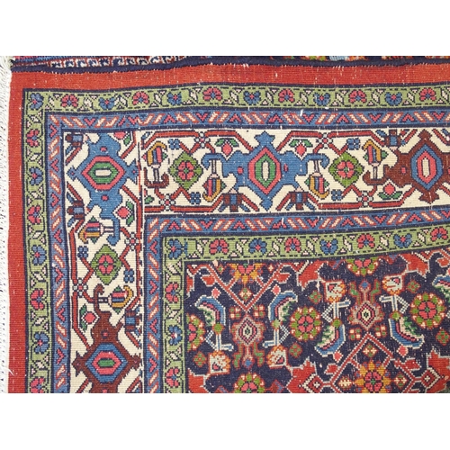 992 - A red ground fine Tabriz rug