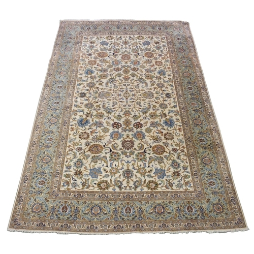 993 - A cream ground Kashan rug