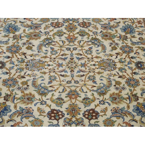 993 - A cream ground Kashan rug