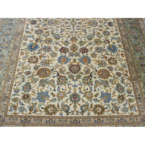 993 - A cream ground Kashan rug