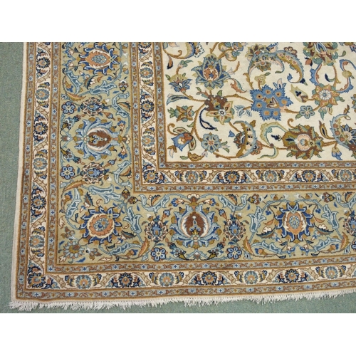 993 - A cream ground Kashan rug