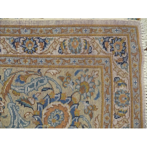 993 - A cream ground Kashan rug