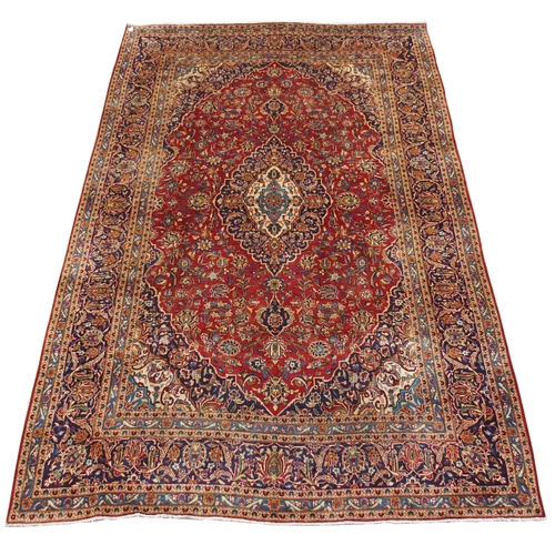 995 - A red ground Kashan rug