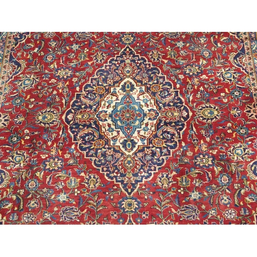 995 - A red ground Kashan rug