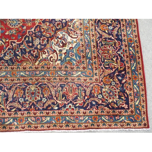 995 - A red ground Kashan rug