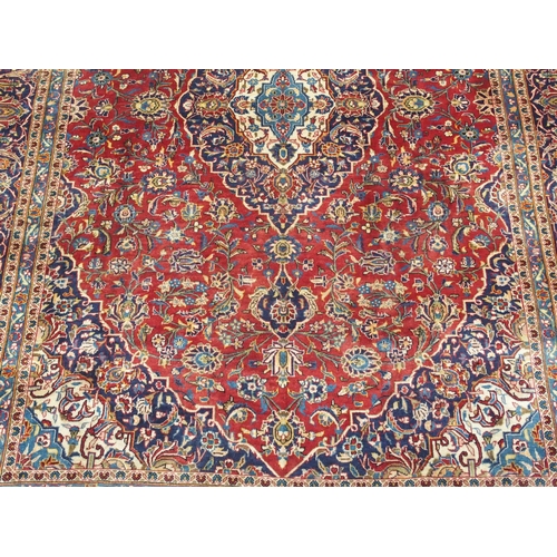 995 - A red ground Kashan rug