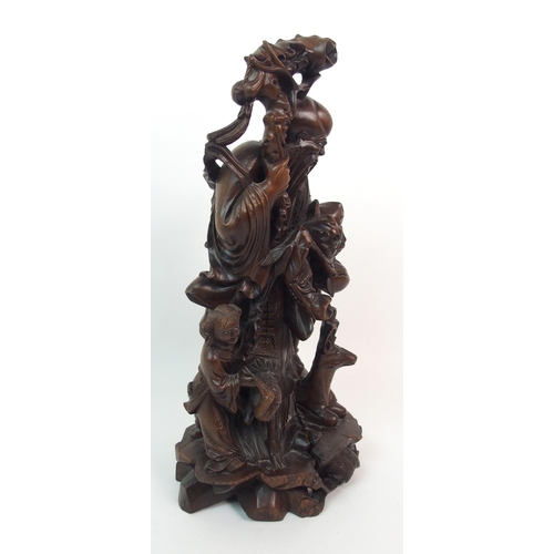 54 - A HARDWOOD CARVING OF A SAGE AND ATTENDANTS