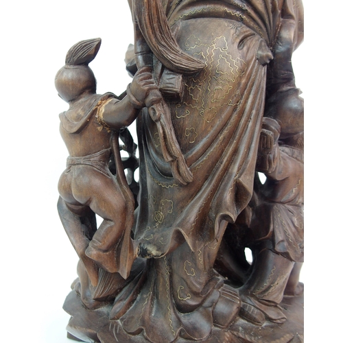 54 - A HARDWOOD CARVING OF A SAGE AND ATTENDANTS