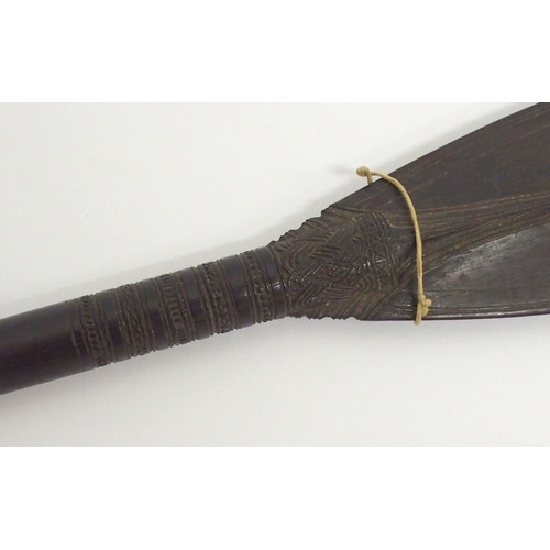 64 - A FINELY CARVED BORNEO CEREMONIAL PADDLE