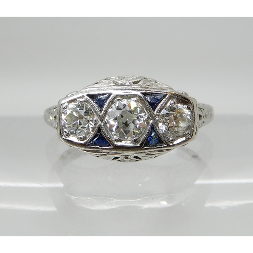 653 - A PLATINUM ART DECO STYLE DIAMOND THREE STONE RING