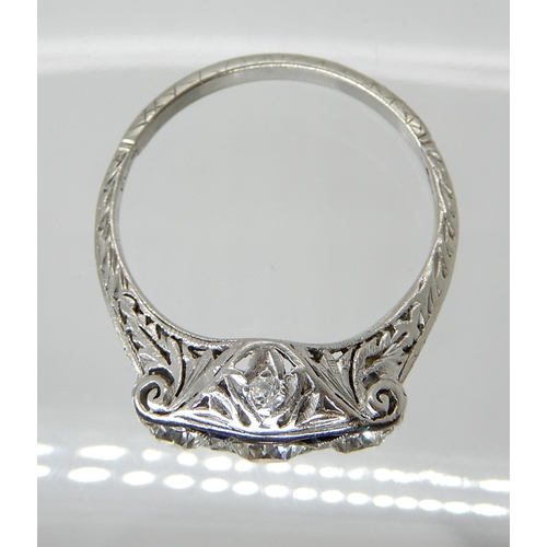 653 - A PLATINUM ART DECO STYLE DIAMOND THREE STONE RING