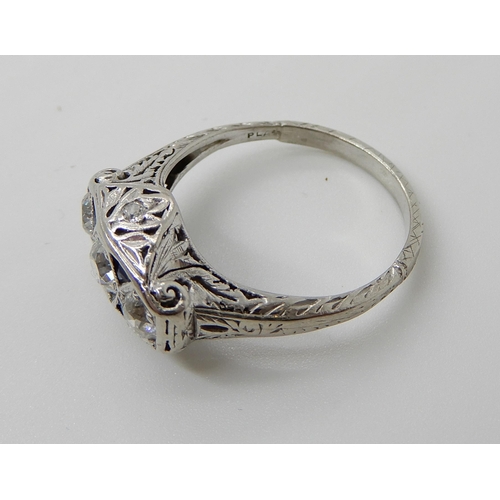 653 - A PLATINUM ART DECO STYLE DIAMOND THREE STONE RING