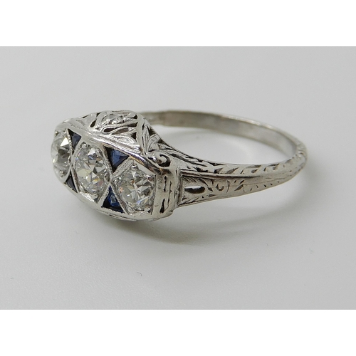 653 - A PLATINUM ART DECO STYLE DIAMOND THREE STONE RING