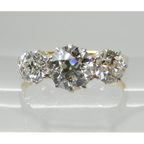 657 - AN 18CT GOLD THREE STONE DIAMOND RING