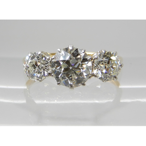 657 - AN 18CT GOLD THREE STONE DIAMOND RING