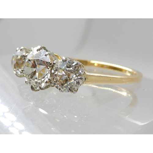 657 - AN 18CT GOLD THREE STONE DIAMOND RING