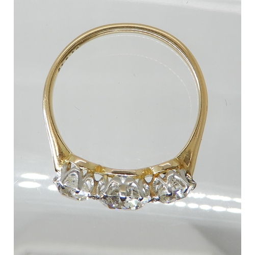 657 - AN 18CT GOLD THREE STONE DIAMOND RING