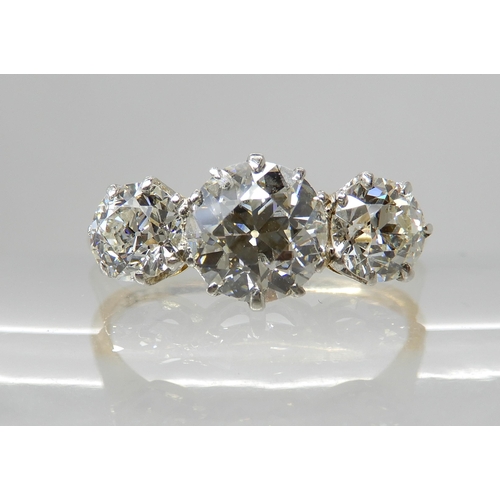 657 - AN 18CT GOLD THREE STONE DIAMOND RING