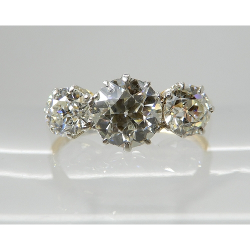 657 - AN 18CT GOLD THREE STONE DIAMOND RING