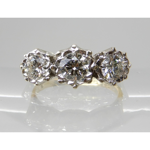 666 - AN 18CT GOLD THREE STONE DIAMOND RING