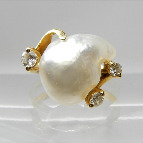 667 - AN 18CT GOLD BAROQUE PEARL AND DIAMOND RING