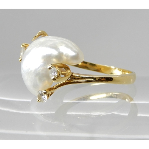 667 - AN 18CT GOLD BAROQUE PEARL AND DIAMOND RING