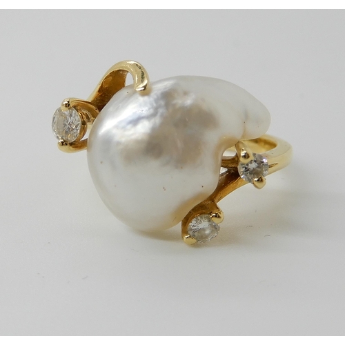 667 - AN 18CT GOLD BAROQUE PEARL AND DIAMOND RING