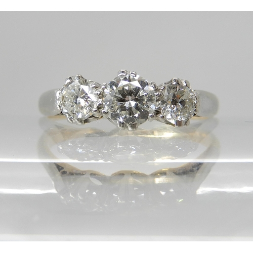 668 - AN 18CT GOLD AND PLATINUM THREE STONE DIAMOND RING