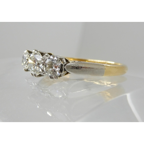 668 - AN 18CT GOLD AND PLATINUM THREE STONE DIAMOND RING