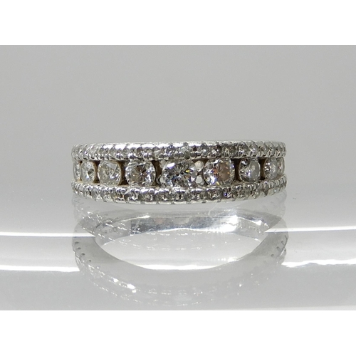 679 - A PLATINUM DIAMOND SET BAND RING