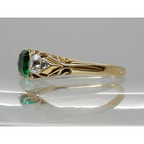 683 - AN EMERALD AND DIAMOND THREE STONE RING