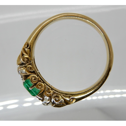 683 - AN EMERALD AND DIAMOND THREE STONE RING