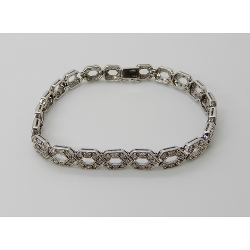 685 - A 9CT WHITE GOLD DIAMOND SET HEXAGONAL LINK BRACELET