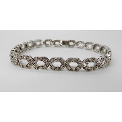 685 - A 9CT WHITE GOLD DIAMOND SET HEXAGONAL LINK BRACELET