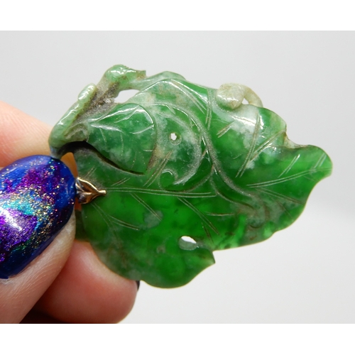 693 - A CHINESE GREEN HARDSTONE PENDANT