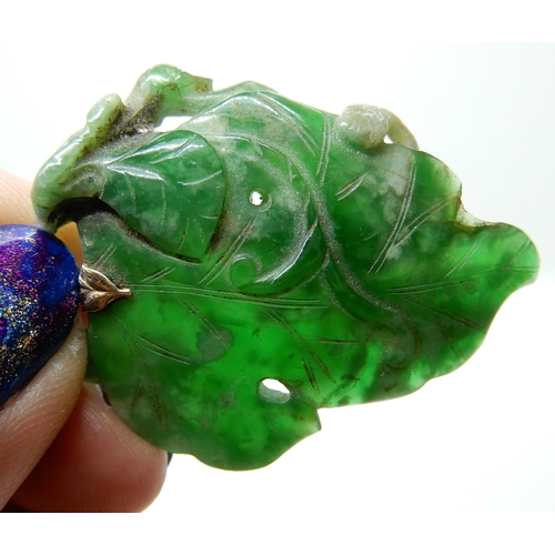 693 - A CHINESE GREEN HARDSTONE PENDANT