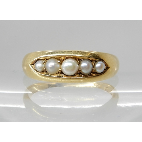 709 - AN 18CT GOLD FIVE PEARL SET RING