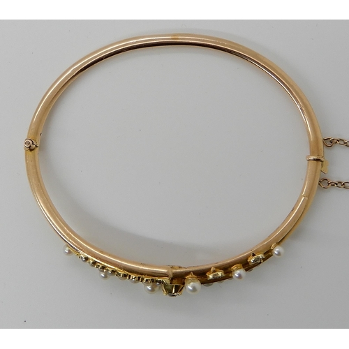 720 - A YELLOW METAL PEARL AND DIAMOND BANGLE